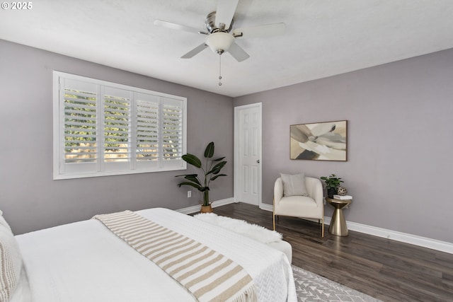 bedroom with dark hardwood / wood-style floors and ceiling fan