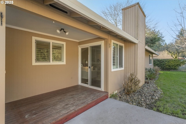 view of home's exterior with a yard and a deck