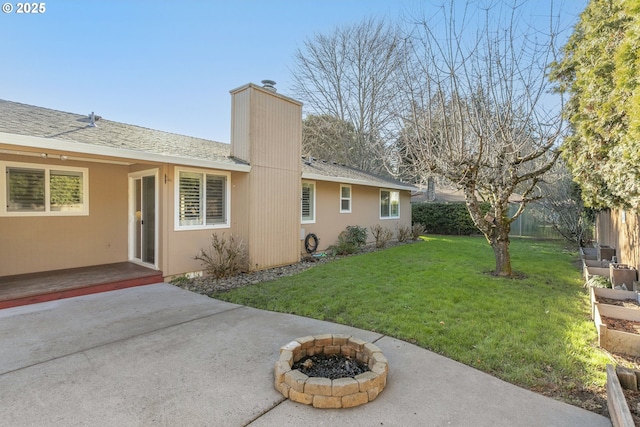 exterior space featuring a yard, a fire pit, and a patio area