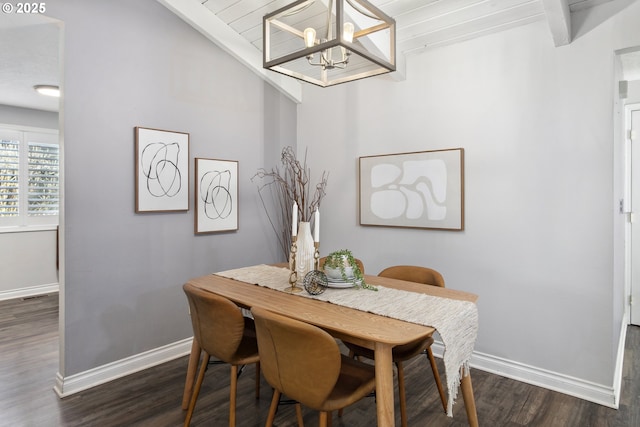 dining room with dark hardwood / wood-style floors, a chandelier, and vaulted ceiling with beams