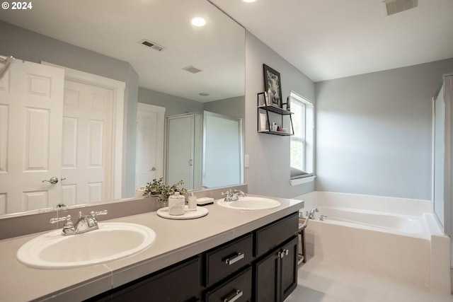 bathroom with vanity and separate shower and tub