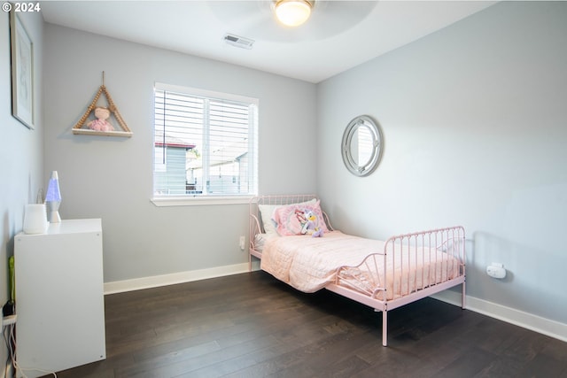 bedroom with dark hardwood / wood-style floors and ceiling fan