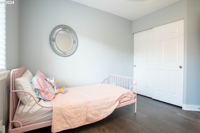 bedroom featuring dark hardwood / wood-style floors and a closet