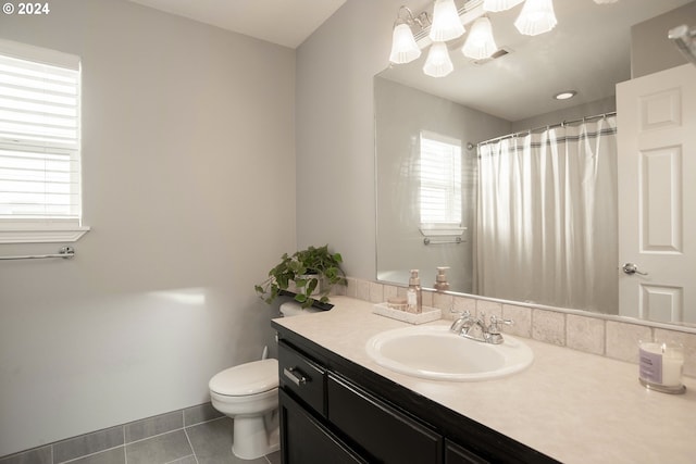 bathroom featuring tile patterned flooring, vanity, and toilet