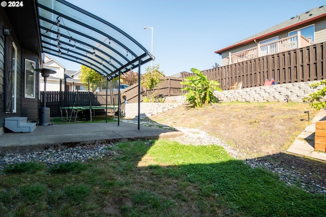 view of yard with a patio and a trampoline