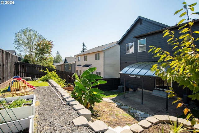 view of yard featuring a patio area and a playground