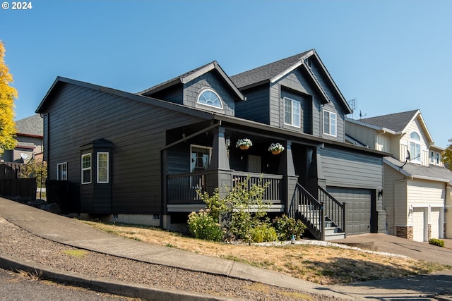 view of front of home featuring a porch and a garage