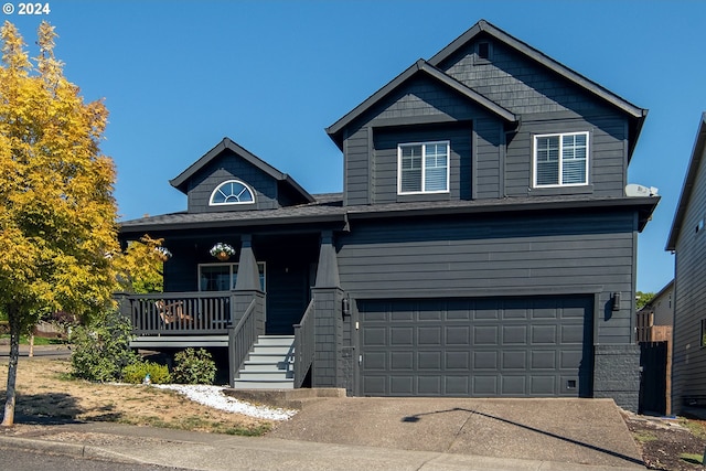 view of front of property with a porch and a garage