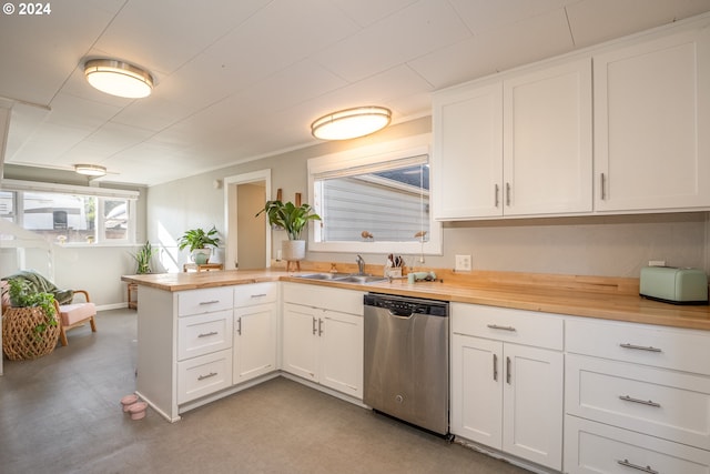 kitchen featuring white cabinetry, kitchen peninsula, dishwasher, wooden counters, and sink