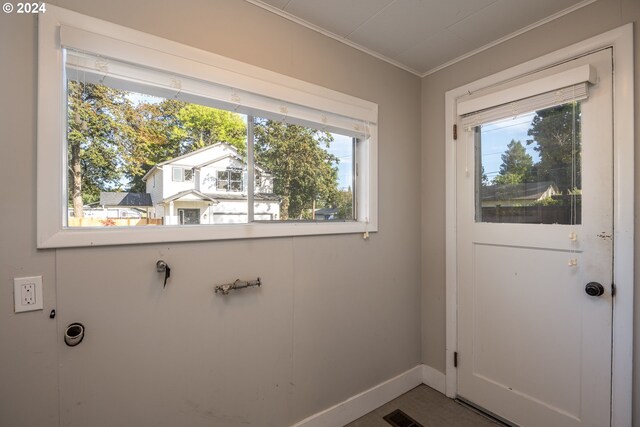 doorway to outside featuring crown molding