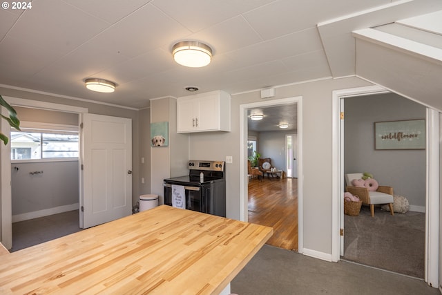 kitchen with white cabinets, butcher block counters, electric range, and dark wood-type flooring