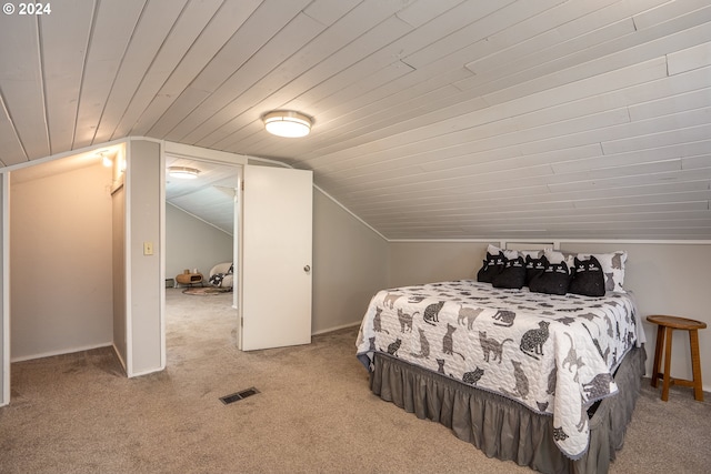 carpeted bedroom with wooden ceiling and vaulted ceiling