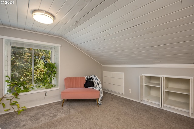 sitting room with crown molding, vaulted ceiling, and carpet