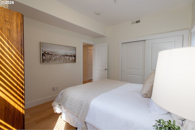 bedroom with a closet and light wood-type flooring