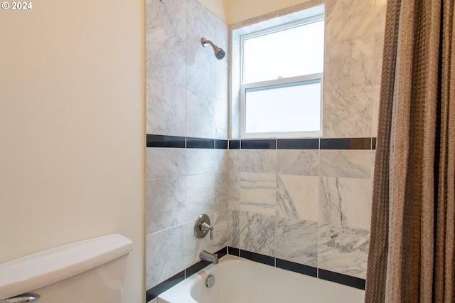 bathroom with shower / bath combo and toilet