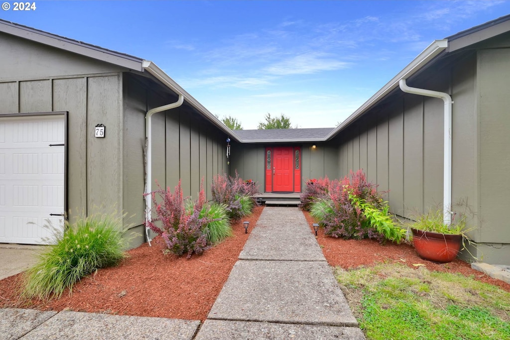 doorway to property featuring a garage