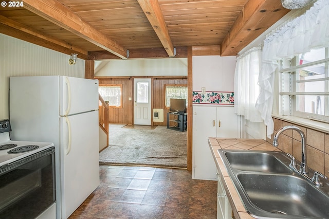 kitchen featuring beam ceiling, white appliances, sink, and wooden ceiling