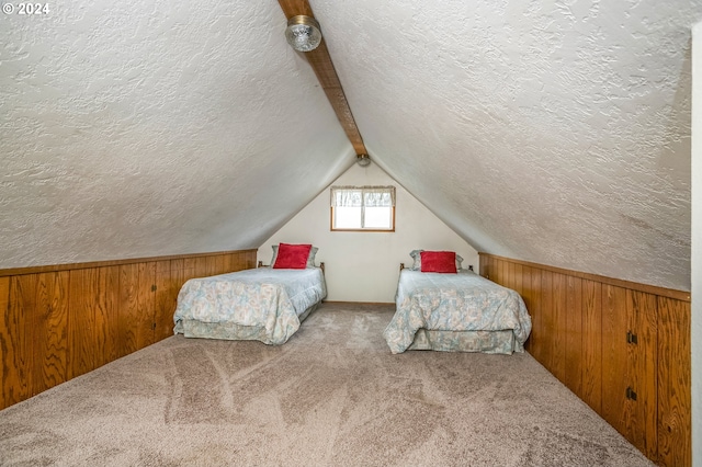 bedroom with light carpet, a textured ceiling, and wood walls