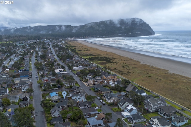 birds eye view of property with a beach view and a water and mountain view