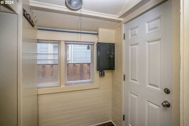 entryway with wood walls