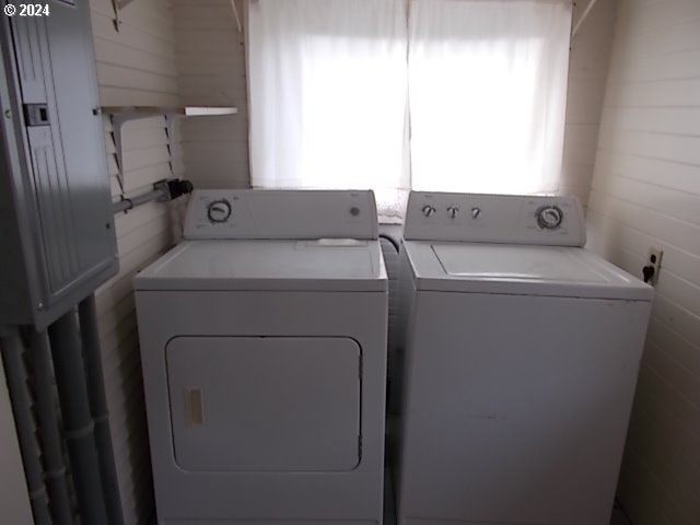 clothes washing area with washer and clothes dryer