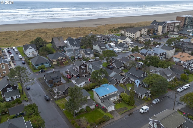 birds eye view of property with a water view and a view of the beach