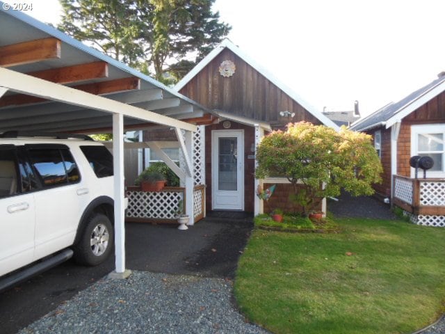 exterior space with a front yard and a carport