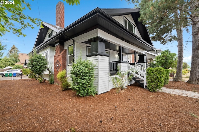 view of side of home with a porch