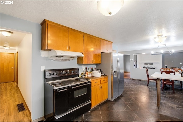 kitchen with stainless steel fridge, black electric range oven, dark wood-type flooring, and a textured ceiling