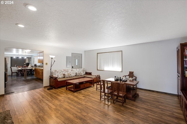 bedroom featuring a textured ceiling and dark hardwood / wood-style floors