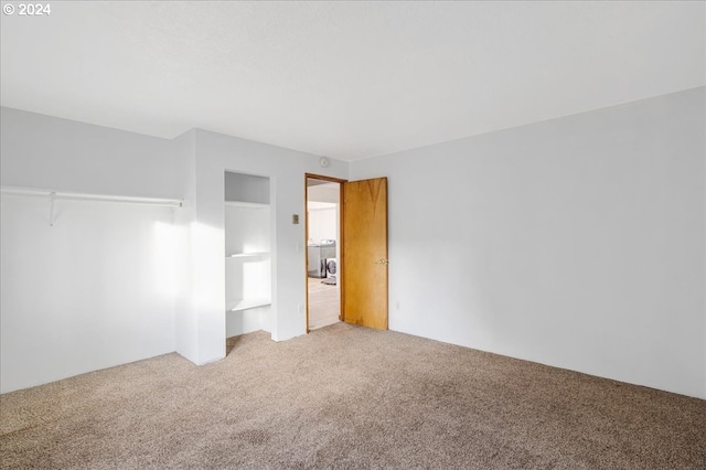 unfurnished bedroom with a closet and carpet