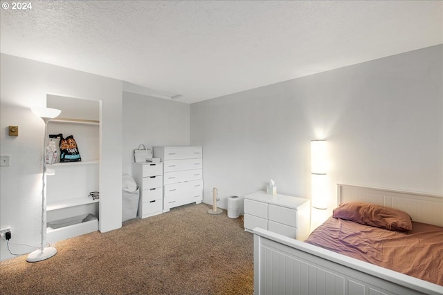 bedroom with carpet and a textured ceiling