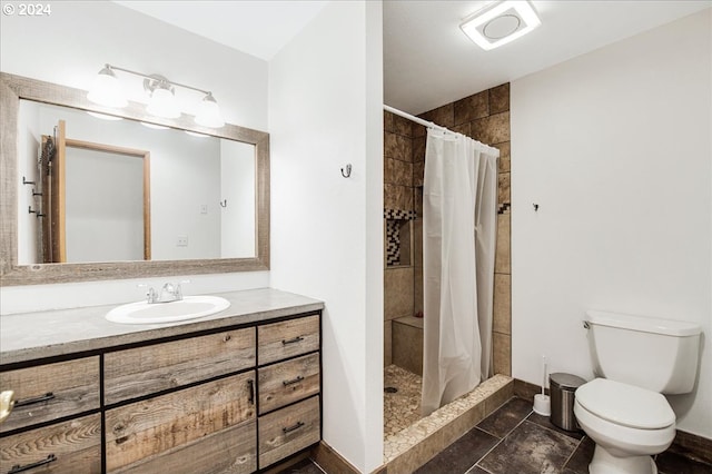 bathroom featuring tile patterned flooring, vanity, curtained shower, and toilet