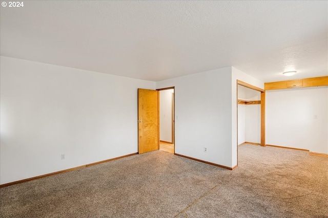 carpeted spare room featuring a textured ceiling