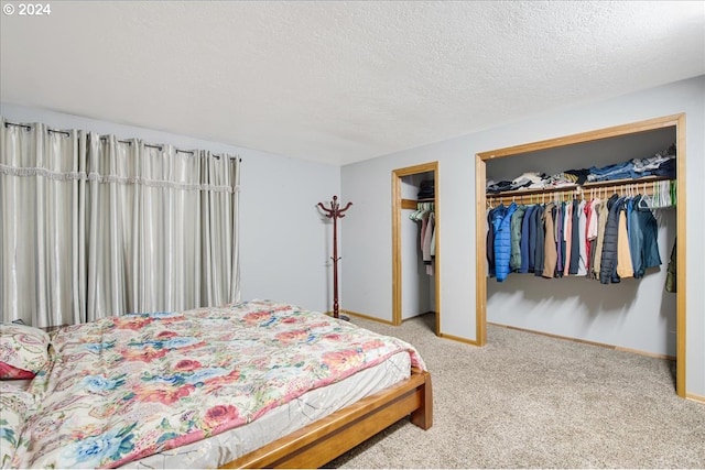 bedroom with carpet and a textured ceiling