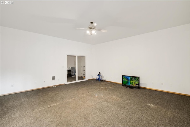 spare room featuring carpet flooring and ceiling fan