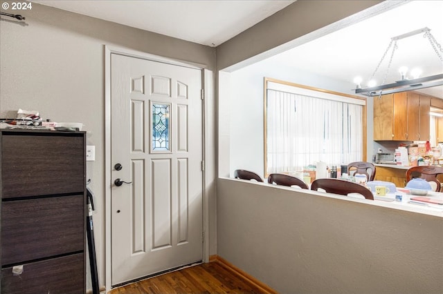 foyer featuring dark hardwood / wood-style floors and an inviting chandelier