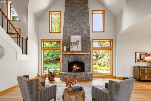 26065 SW Baker Rd, Sherwood, OR 97140 - living area with baseboards, high vaulted ceiling, wood finished floors, and a fireplace