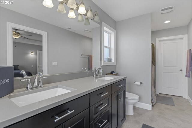 bathroom featuring vanity, toilet, ceiling fan, and tile patterned floors