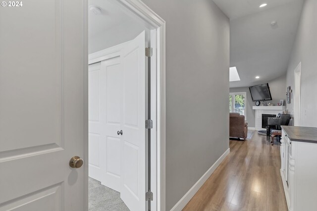 corridor with light hardwood / wood-style flooring