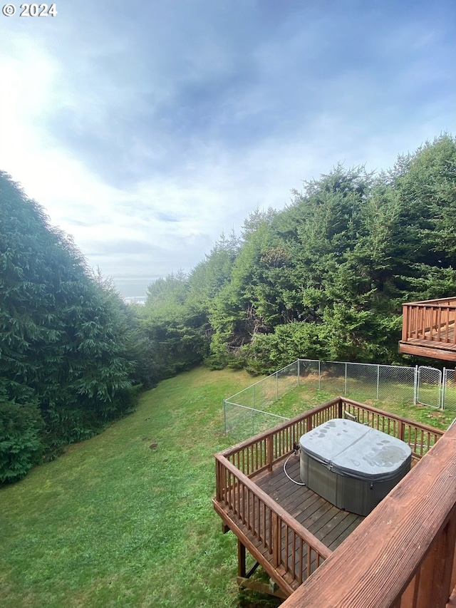 view of yard with a covered hot tub and a deck