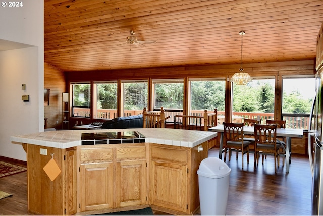 kitchen with tile countertops, wooden ceiling, a center island, and pendant lighting