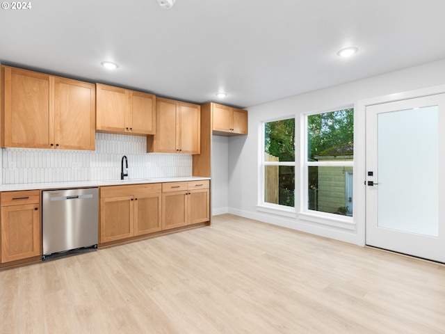 kitchen featuring decorative backsplash, light hardwood / wood-style floors, dishwasher, and sink