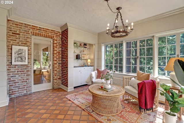 living area with ornamental molding, tile patterned floors, brick wall, and an inviting chandelier