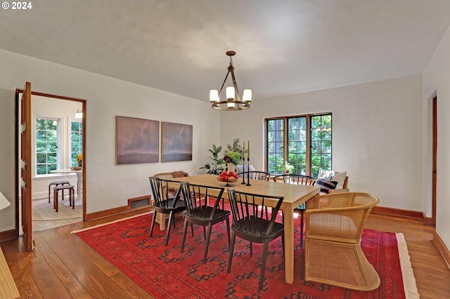 dining area with a healthy amount of sunlight, visible vents, and hardwood / wood-style floors