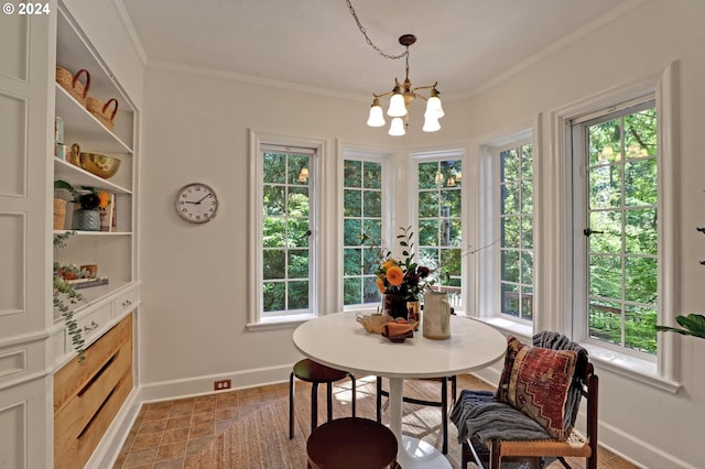 dining room with ornamental molding, a wealth of natural light, a chandelier, and baseboards