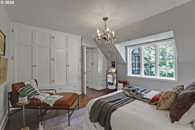 bedroom featuring dark wood-type flooring and a chandelier