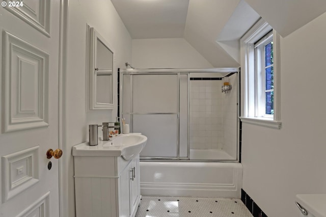 full bathroom with tile patterned flooring, vanity, toilet, and bath / shower combo with glass door