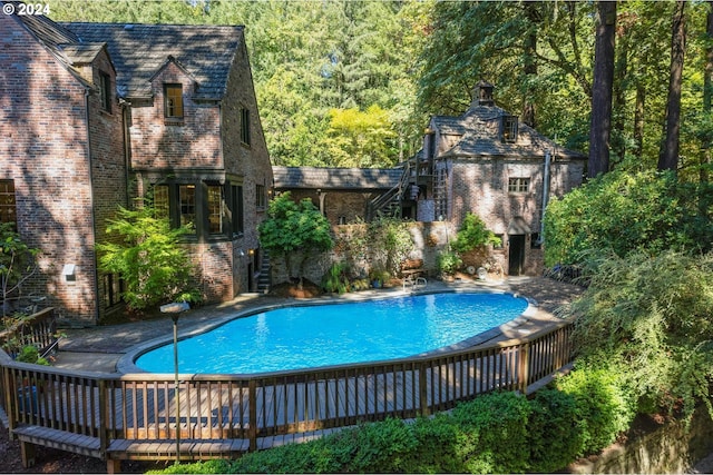 view of pool featuring a deck and a fenced in pool