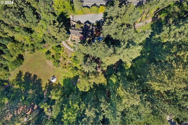 birds eye view of property featuring a view of trees